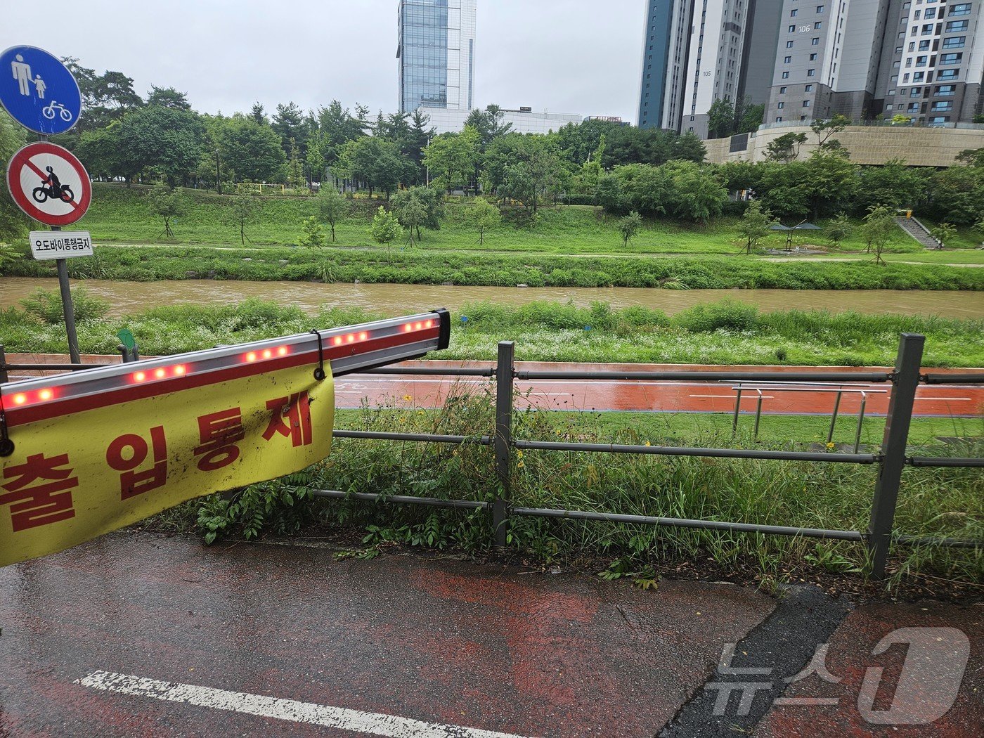 본문 이미지 - 호우특보가 발효된 17일 강원 춘천 퇴계동 도심 공지천 일대 산책로가 통제돼 있다. 2024.7.17/뉴스1 ⓒ News1 한귀섭 기자