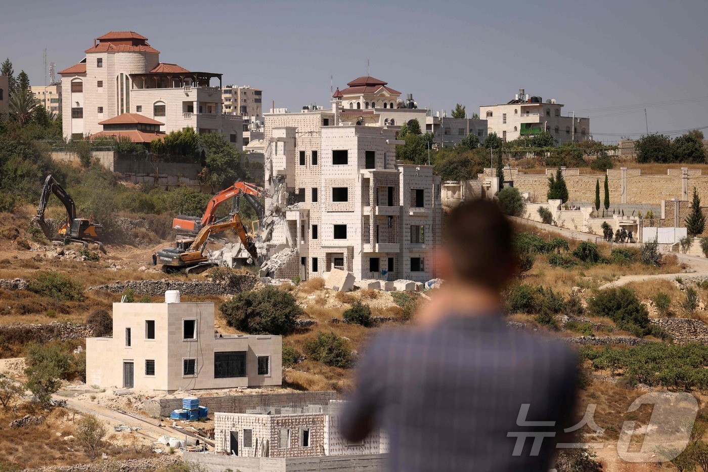 (헤브론 AFP=뉴스1) 강민경기자 = 팔레스타인 자치령 요르단강 서안 헤브론에서 25일 이스라엘군이 불도저를 동원해 허가를 받지않고 지어지던 팔레스타인인의 가옥을 깨부수고 있다. …