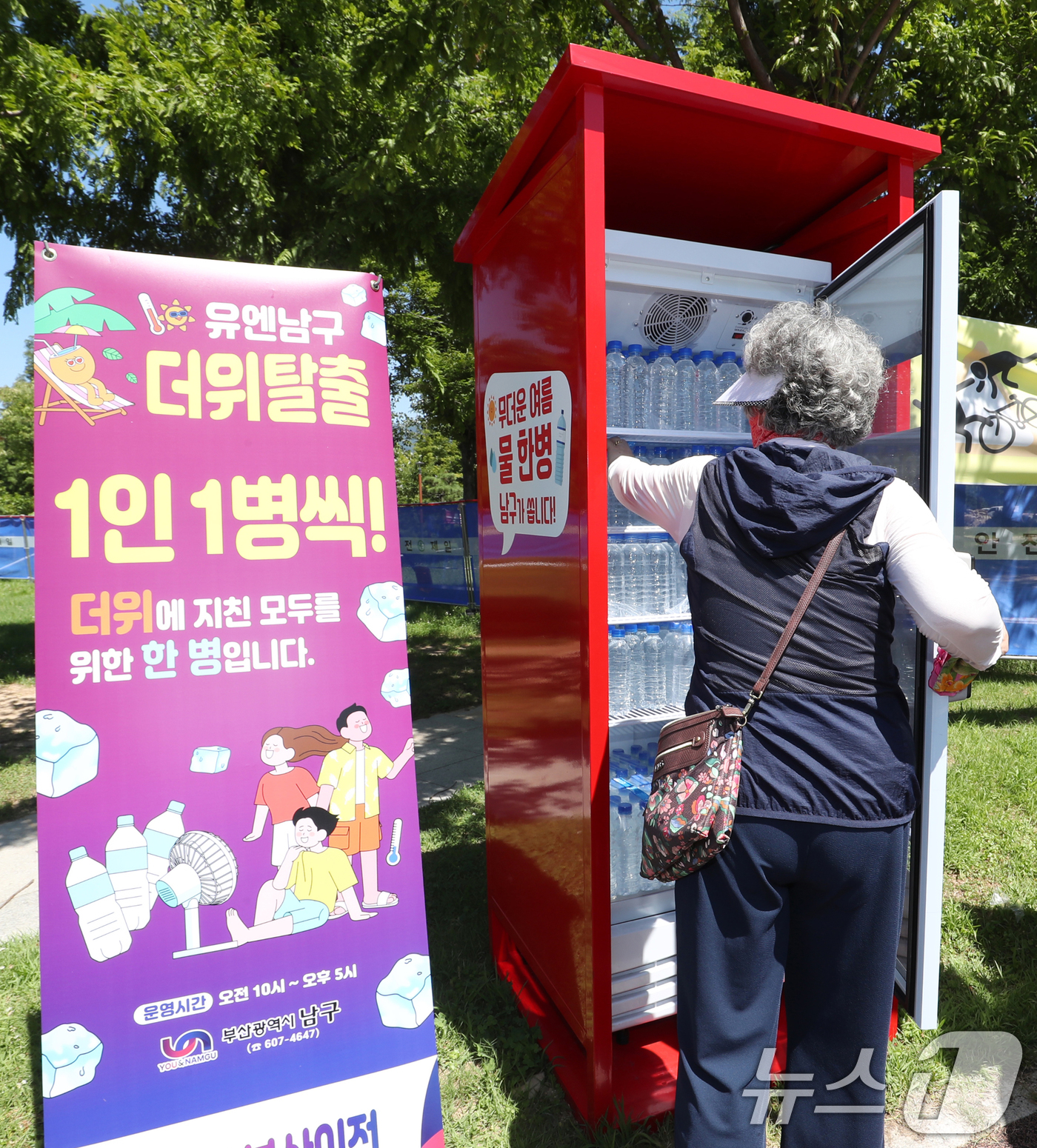 (부산=뉴스1) 윤일지 기자 = 부산에 폭염경보가 이어진 31일 부산 남구 평화공원에 여름철 폭염 대비 생수냉장고가 설치된 가운데 시민들이 생수냉장고에서 생수를 꺼내고 있다.부산 …