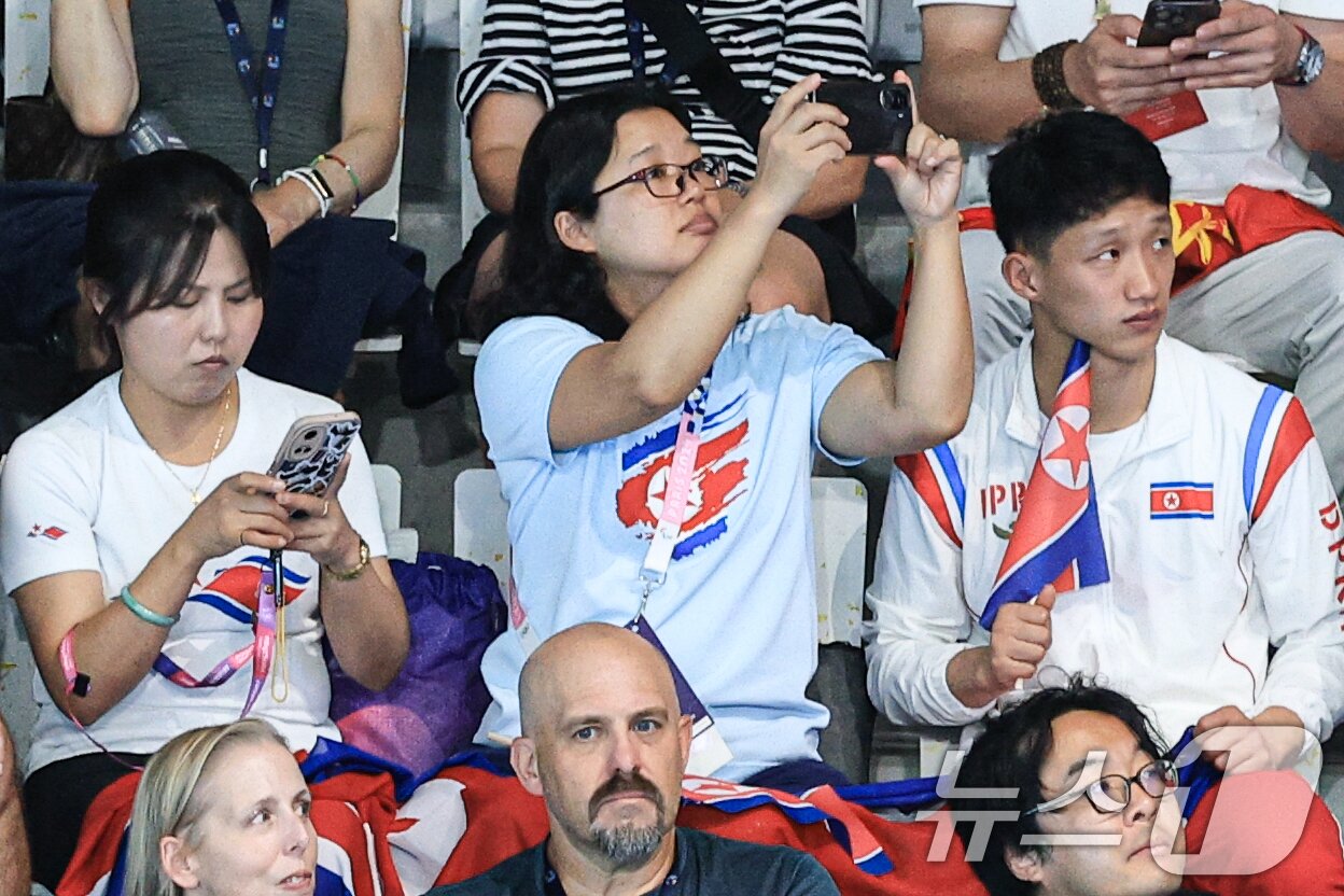 본문 이미지 - 31일 오후&#40;한국시간&#41; 프랑스 생드니 아쿠아틱스 센터에서 열린 2024 파리올림픽 다이빙 여자 싱크로나이즈드 10M 플랫폼 경기를 찾은 북한 관계자가 스마트폰을 이용해 촬영하고 있다 . 2024.7.31/뉴스 ⓒ News1 박정호 기자