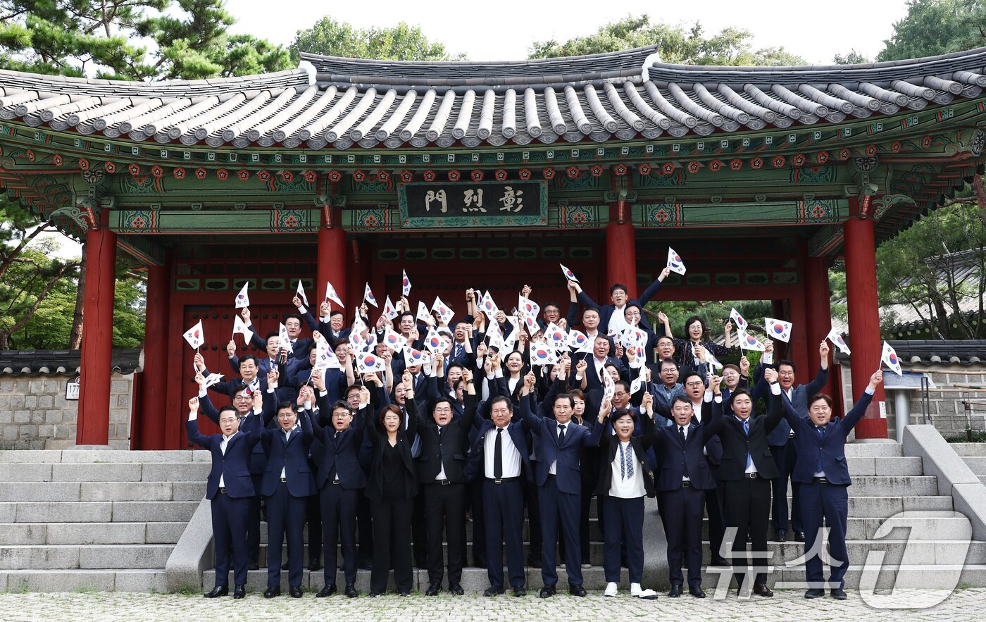 박찬대 더불어민주당 대표 직무대행 겸 원내대표를 비롯한 지도부가 제79주년 광복절인 15일 오전 서울 용산구 효창공원에서 임정요인&#40;이동녕·조성환·차리석&#41; 묘역 참배에 앞서 태극기를 들고 만세삼창을 하고 있다. 2024.8.15/뉴스1 ⓒ News1 김민지 기자