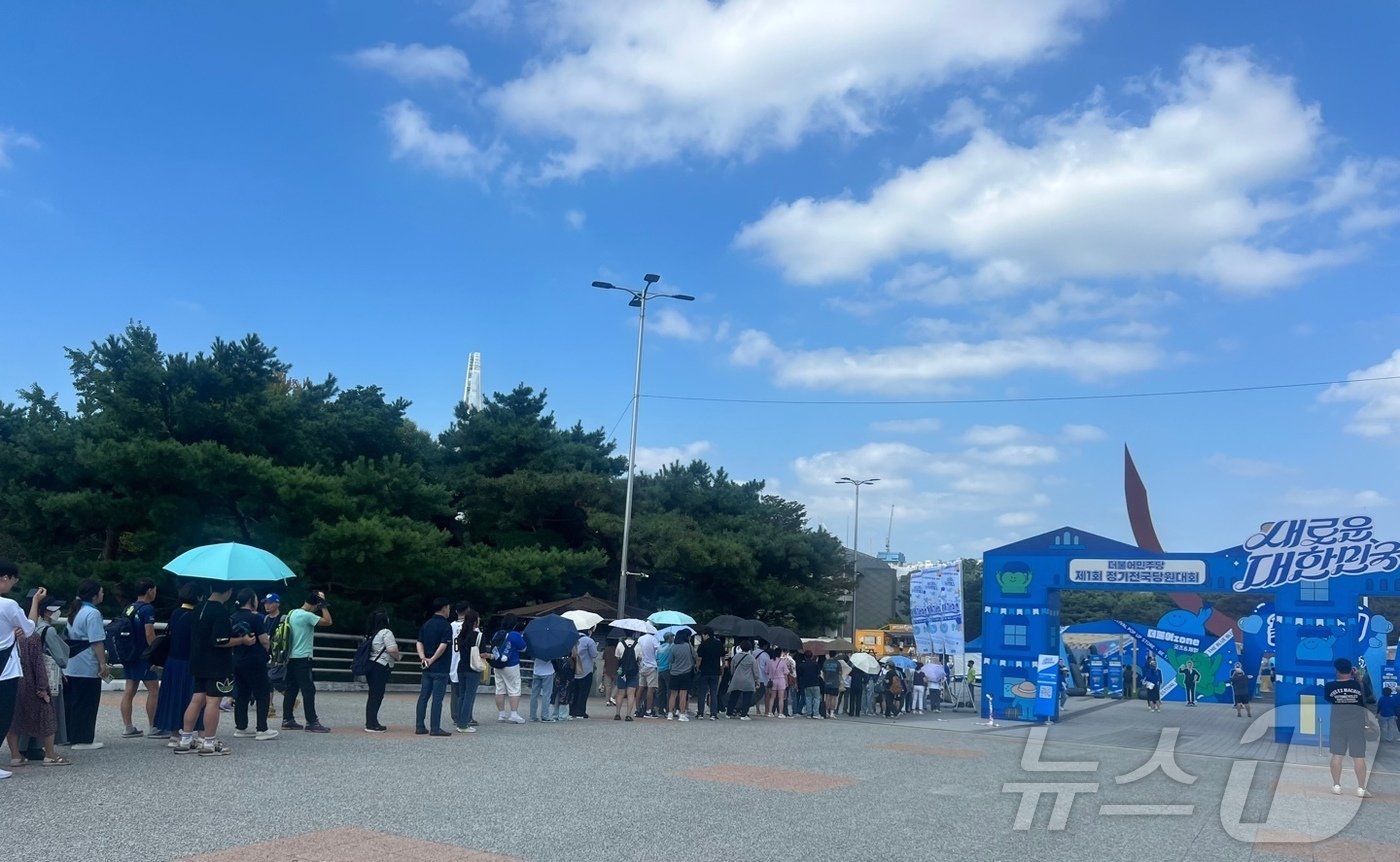 본문 이미지 - 18일 오전 10시 서울 송파구 올림픽공원 KSPO돔 앞 한얼광장에 더불어민주당 굿즈를 사기 위해 사람들이 줄을 선 모습 ⓒ 뉴스1 임윤지 기자