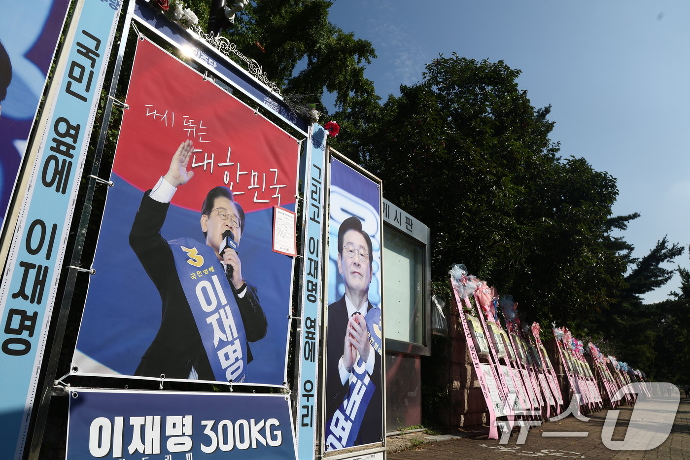 19일 오전 서울 여의도 국회 정문 앞에 이재명 더불어민주당 대표 연임을 축하하는 화환이 놓여있다. 2024.8.19/뉴스1 ⓒ News1 김민지 기자