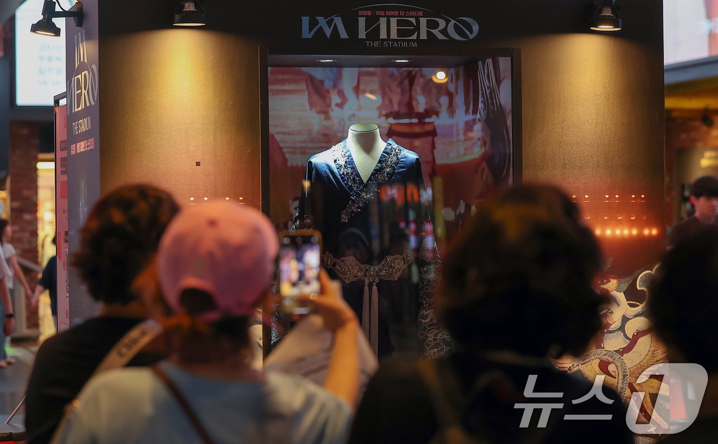 본문 이미지 - 22일 오후 서울 CGV 용산아이파크몰에 마련된 ‘임영웅│아임 히어로 더 스타디움’ 무대 의상 전시 포토존에서 시민들이 사진을 찍고 있다. 2024.8.22/뉴스1 ⓒ News1 김진환 기자