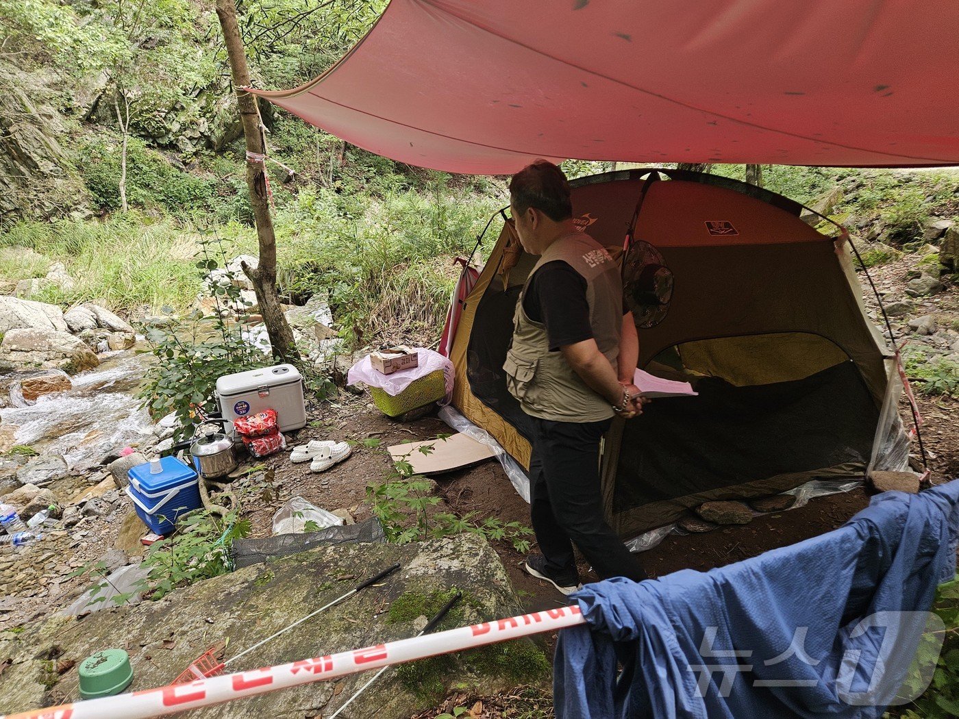 본문 이미지 - 7일 강원 홍천 북방면 도사곡리의 한 산간 계곡에 누군가 텐트와 취사도구를 갖춰 놓고 사라져 홍천국유림관리소 단속반이 이를 확인하고 있다.2024.8.7 한귀섭 기자