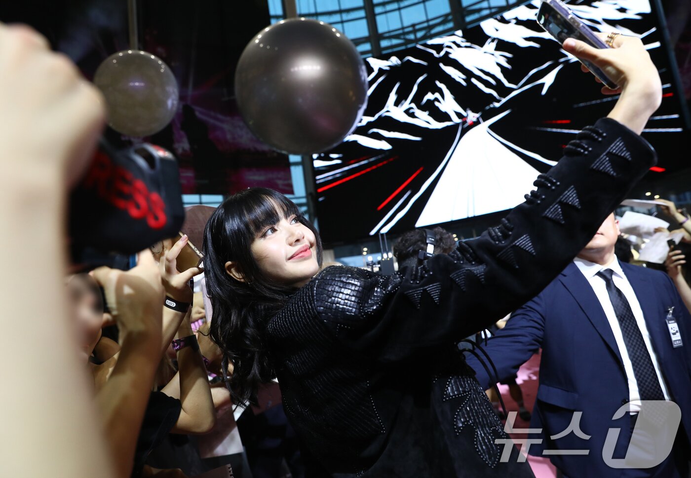본문 이미지 - 그룹 블랙핑크(BLACK PINK)의 리사가 9일 오후 서울 영등포구 타임스퀘어 영등포점에서 진행된 ‘본 핑크 인 시네마스(BORN PINK IN CINEMAS)’ 핑크 카펫에서 셀카를 찍고 있다. ⓒ News1 권현진 기자