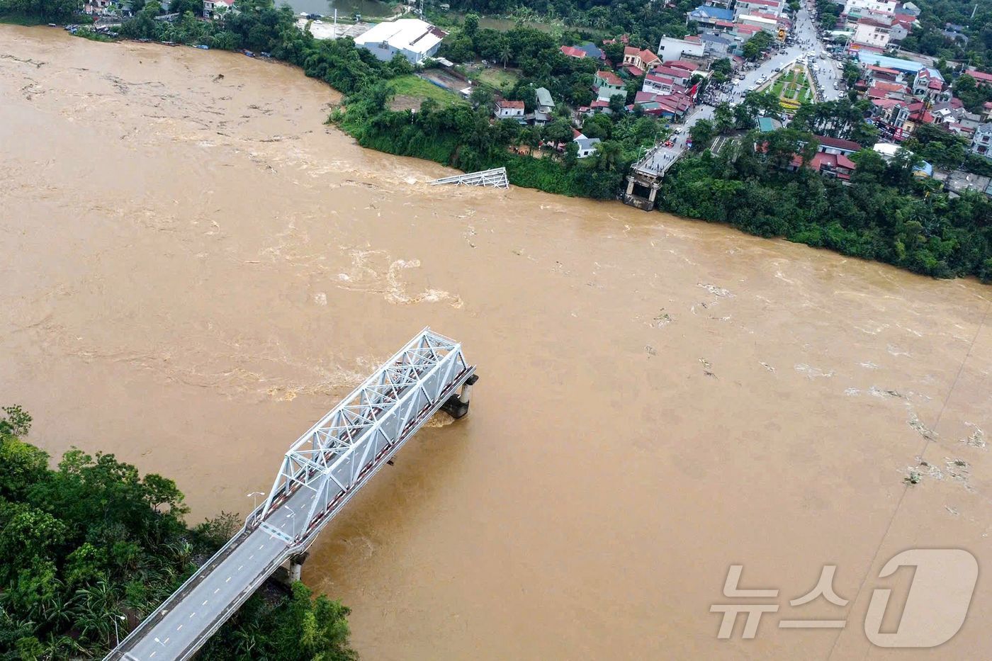 본문 이미지 - 9일 (현지시간) 슈퍼 태풍 '야기'가 강타한 베트남 북부 푸토성에서 홍강을 지나는 퐁차우 철교 교각이 홍수로 유실되면서 붕괴된 모습이 보인다. 2024.09.10 ⓒ AFP=뉴스1 ⓒ News1 우동명 기자