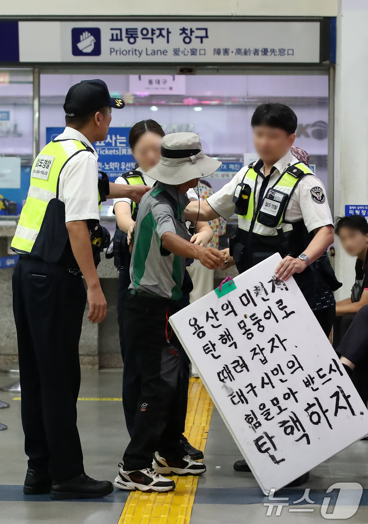 (대구=뉴스1) 공정식 기자 = 추석 연휴 마지막 날인 18일 오전 대구 동구 동대구역 대합실에서 한 남성이 탄핵 관련 문구가 적힌 피켓을 들고 고성을 지르다 철도경찰에 제지당하고 …