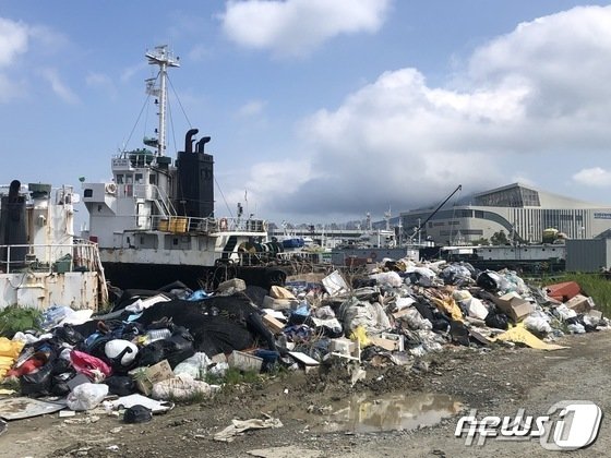 본문 이미지 - 부산항 제5물양장 인근 선박들 사이로 각종 쓰레기들이 무단으로 버려져 있다. 