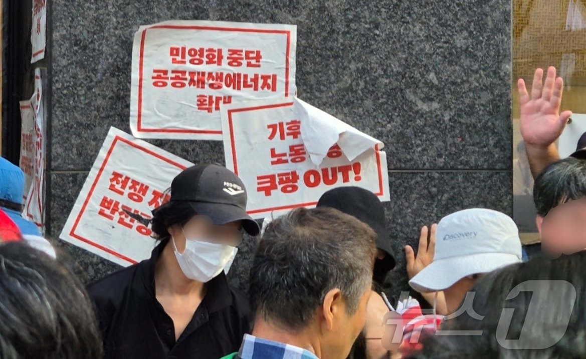 본문 이미지 - '907 기후정의행진' 일부 참가자들이 7일 오후 선릉역 인근 쿠팡 신사옥 건물에 홍보 전단물을 붙이려다 경찰과 실랑이를 벌였다. / 뉴스1 조유리 기자