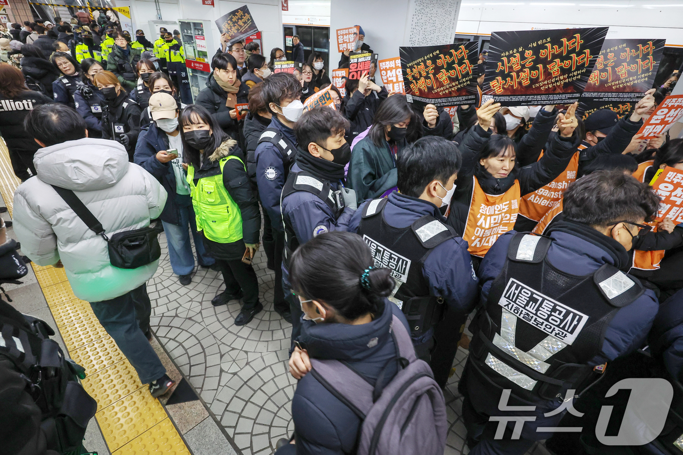 (서울=뉴스1) 민경석 기자 = 2일 오전 서울 종로구 3호선 안국역 승강장에서 새해 첫 출근길 지하철 탑승 시위에 나선 전국장애인차별철폐연대(전장연) 관계자들과 탑승 저지에 나선 …