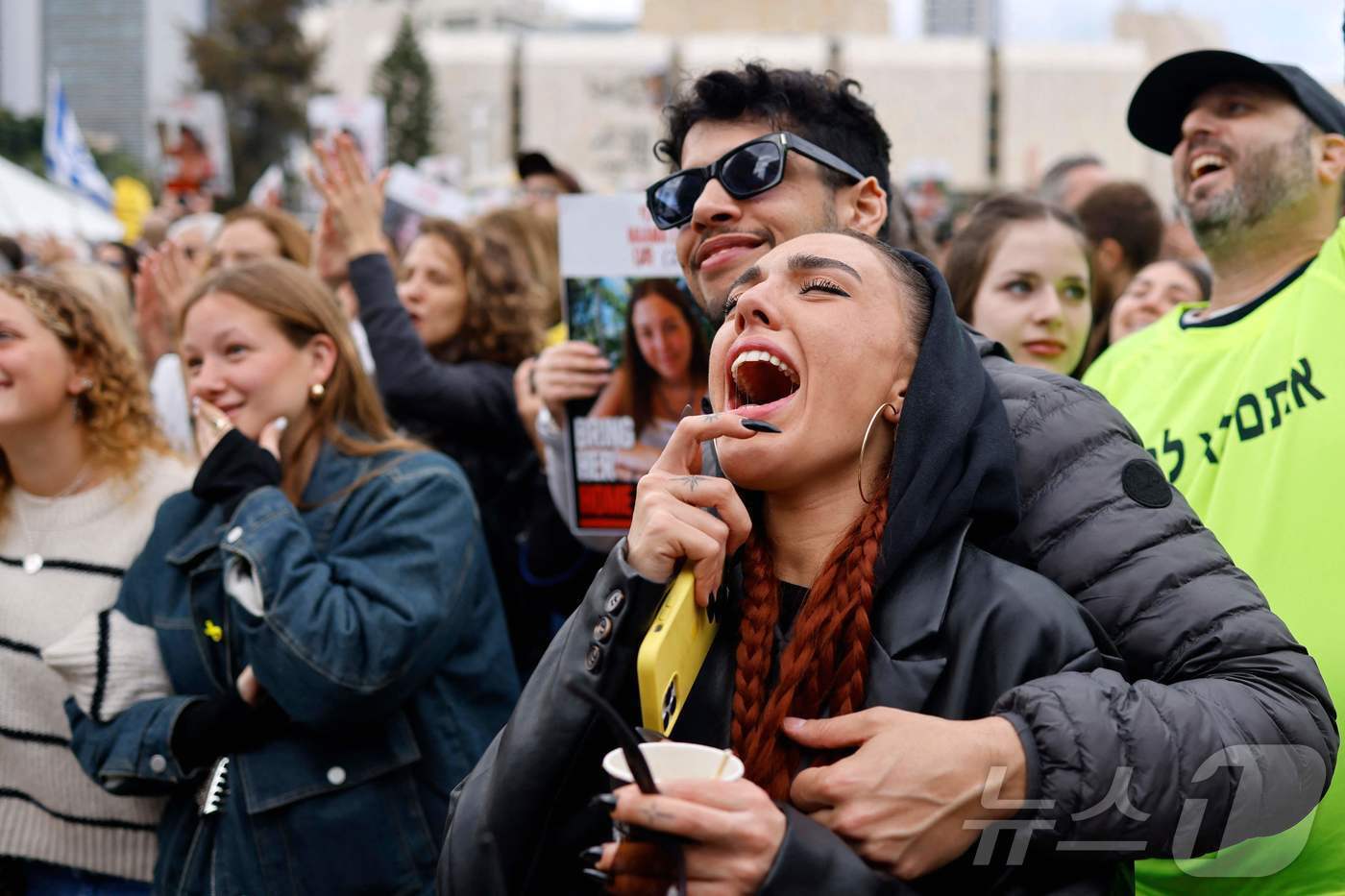 본문 이미지 - 25일(현지시간) 이스라엘 텔아비브 인질 광장에서 시민들이 하마스로부터 풀려난 군인 인질의 석방 소식에 환호하고 있다. 2025.01.25/ ⓒ AFP=뉴스1 ⓒ News1 권진영 기자