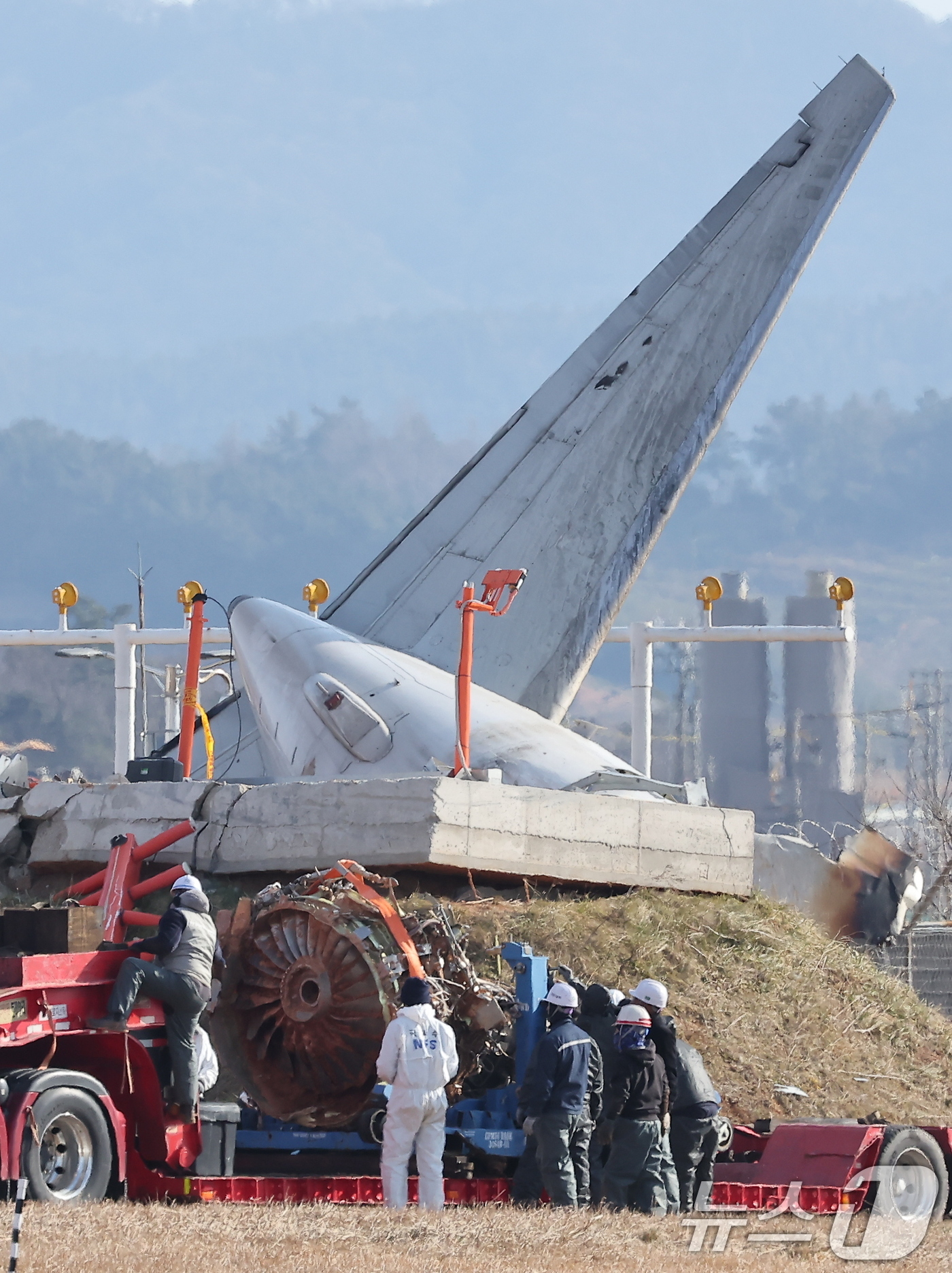 (무안=뉴스1) 김진환 기자 = 제주항공 여객기 참사 엿새째인 3일 오후 전남 무안국제공항 참사 현장에서 로컬라이저(방위각시설) 둔덕에 파묻힌 제주항공 7C2216편의 엔진이 트럭 …