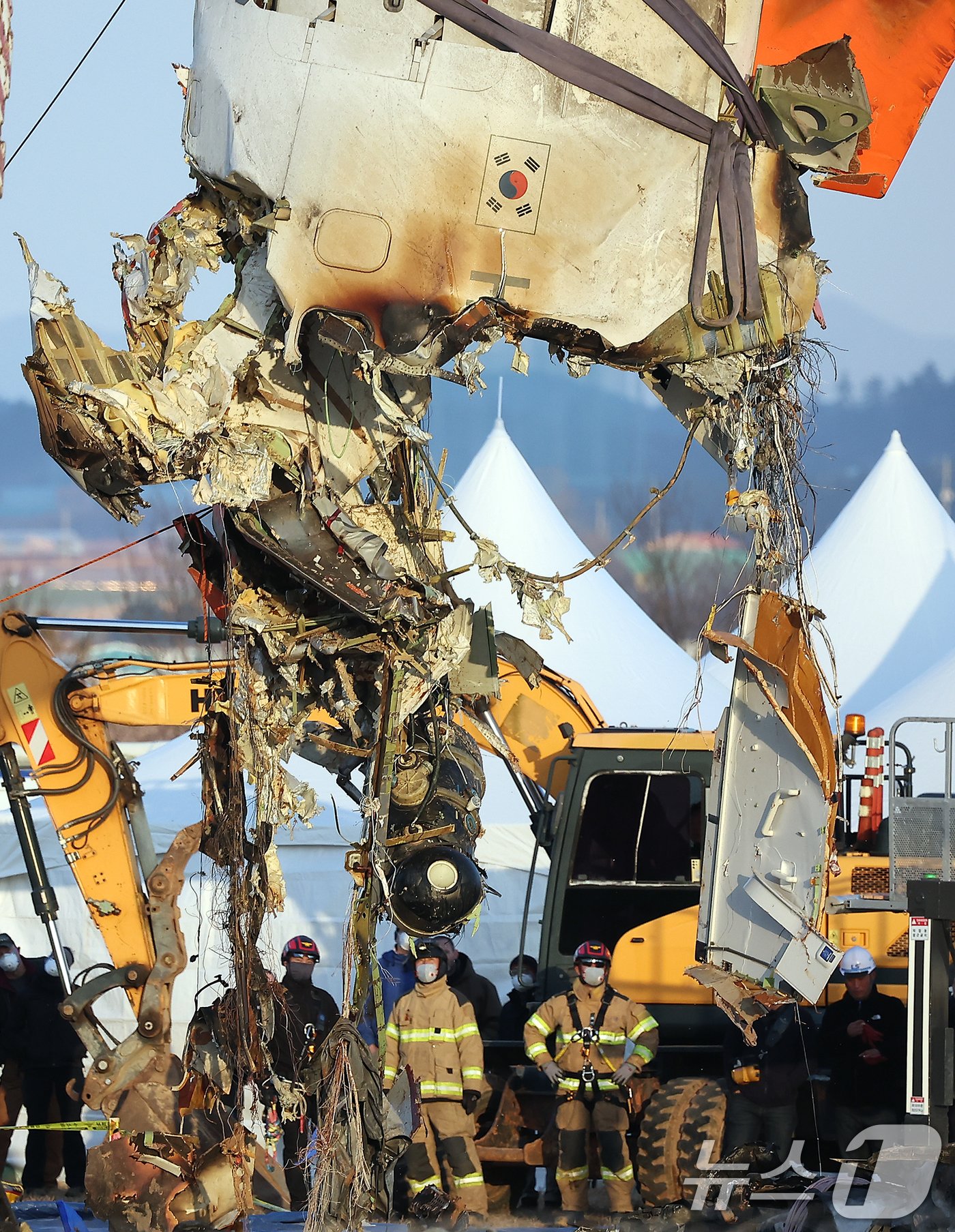 본문 이미지 - 제주항공 여객기 참사 엿새째인 3일 오후 전남 무안국제공항 참사 현장에서 제주항공 7C2216편 사고 기체의 꼬리 부분이 크레인에 의해 인양되고 있다. 2025.1.3/뉴스1 ⓒ News1 김진환 기자