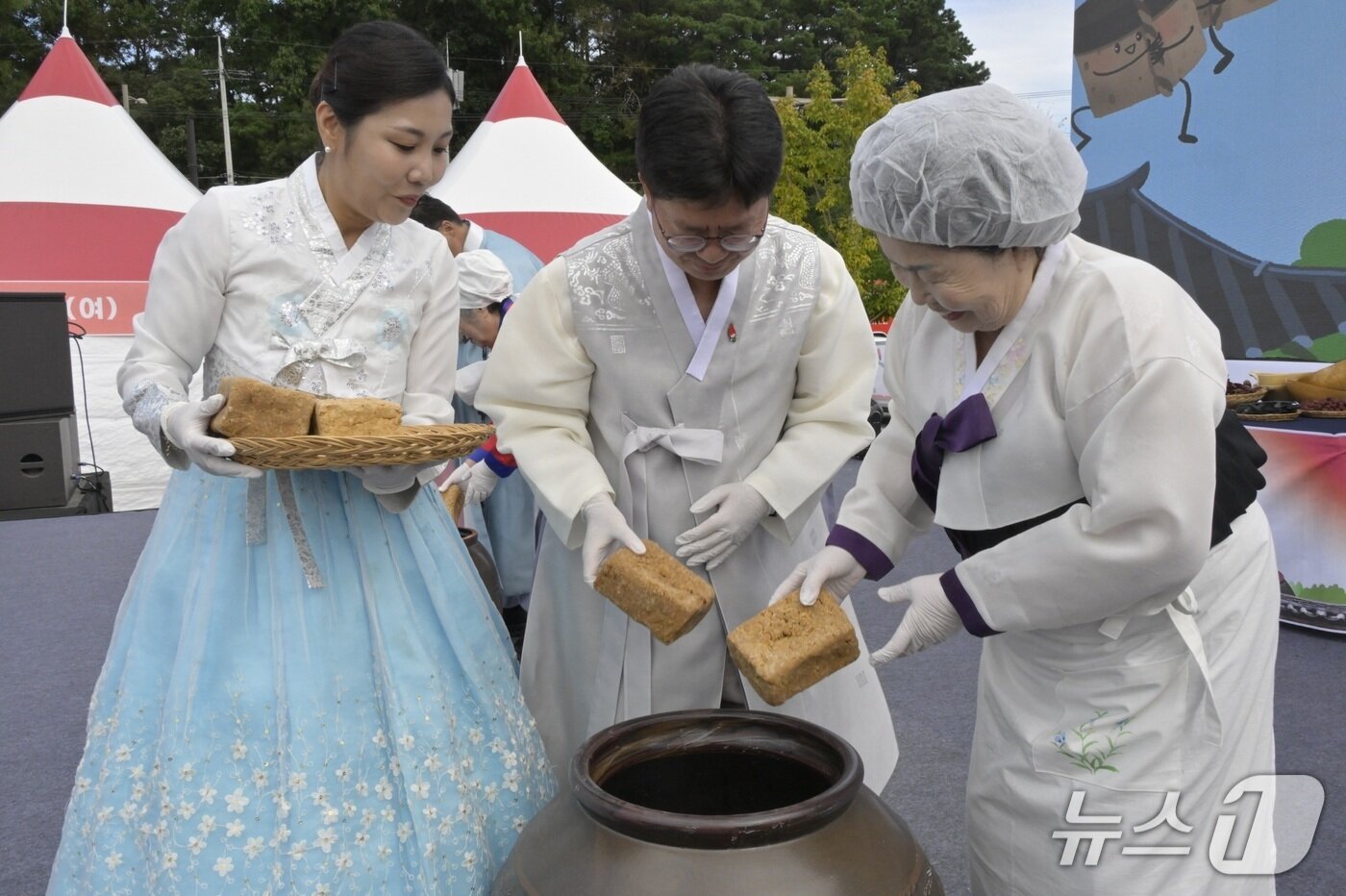 본문 이미지 - 이성호 순창부군수가 장류 명인과 함께 메주를 항아리에 넣는 &#39;장 담그기&#39; 퍼포먼스를 선보이고 있다.&#40;순창군 제공. 재판매 및 DB금지&#41;/뉴스1 