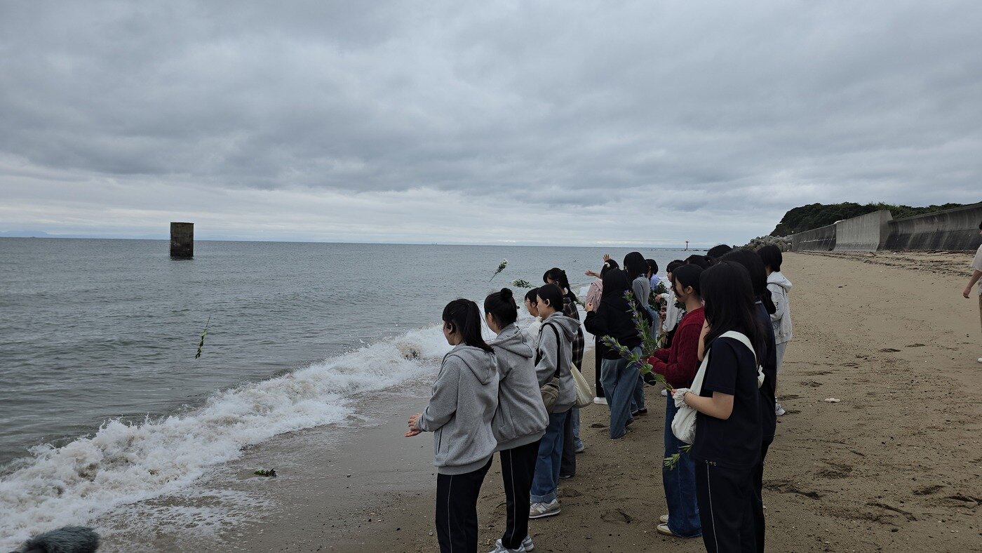 본문 이미지 - 19일, 부산 남성여자고등학교 학생들이 사비에르고와 하기코엔고 학생들과 함께 장생탄광 수몰사고 현장 앞 바닷가에서 추도식을 올린후 꽃을 바다에 띄우고 희생자들의 명복을 빌고 있다. (히스토리D 제공)