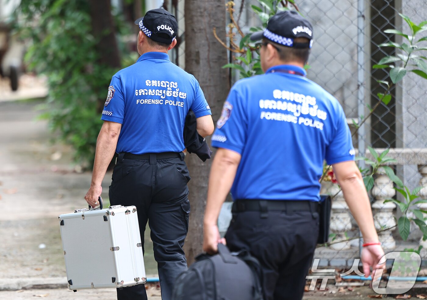 본문 이미지 - 캄보디아 현지 경찰이 20일&#40;현지시간&#41; 캄보디아 프놈펜 턱틀라사원에서 지난 8월 보코산 지역의 온라인스캠범죄단지에 감금돼 고문 끝에 숨진 대학생 박모씨의 시신을 부검하기 위해 안치실로 들어가고 있다. 2025.10.20/뉴스1 ⓒ News1 김도우 기자