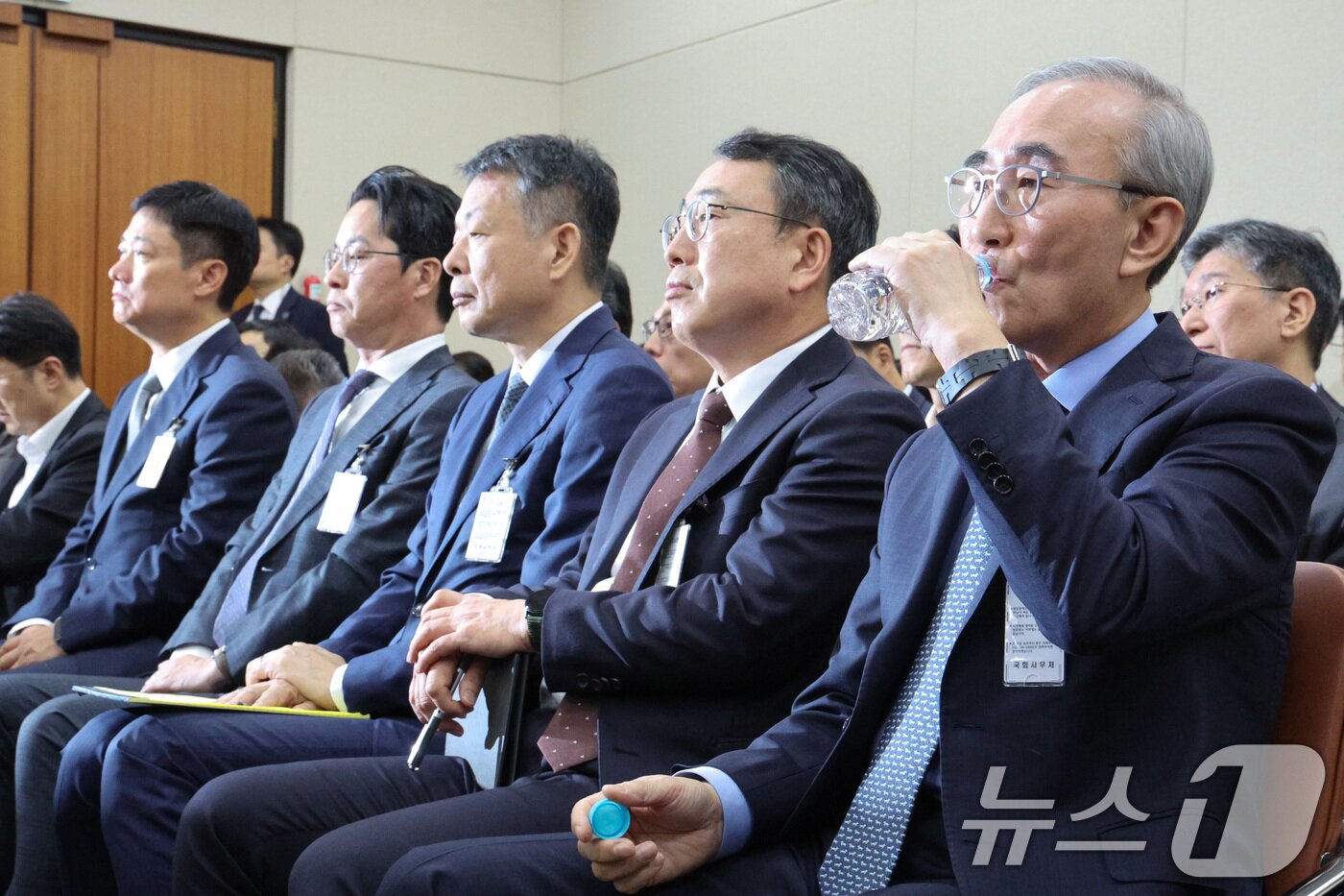본문 이미지 - 김영섭 KT 대표가 21일 서울 여의도 국회 과학기술정보방송통신위원회에서 열린 정보통신산업진흥원 등에 대한 국정감사에서 목을 축이고 있다. 왼쪽부터 홍범식 LGU+ 대표, 조좌진 롯데카드 대표, 김광일 MBK 대표이사, 유영상 SKT 대표, 김 대표. 2025.10.21/뉴스1 ⓒ News1 신웅수 기자