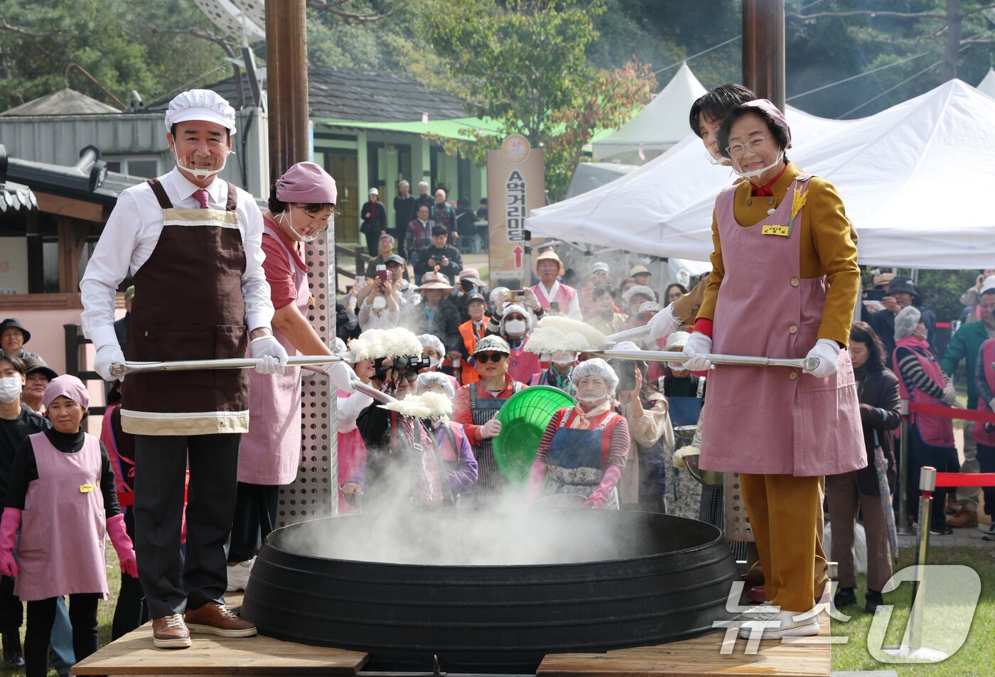 본문 이미지 - ‘제24회 이천쌀문화축제’가 개막한 22일 경기 이천시 모가면 이천농업테마공원에서 김경희 이천시장과 행사 관계자들이 2000인분 가마솥 밥 앞에서 기념촬영을 하고 있다. 2025.10.22/뉴스1 ⓒ News1 김영운 기자