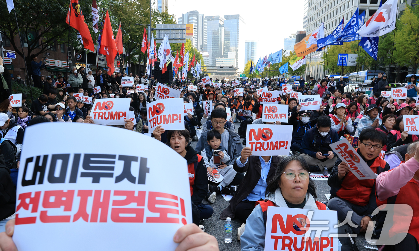 (서울=뉴스1) 이호윤 기자 = 트럼프저지공동행동 회원들이 25일 서울 중구 세종대로에서 열린 대미투자 전면 재검토 NO 트럼프 범시민대행진에 참가해  피켓을 들고 구호를 외치고 …
