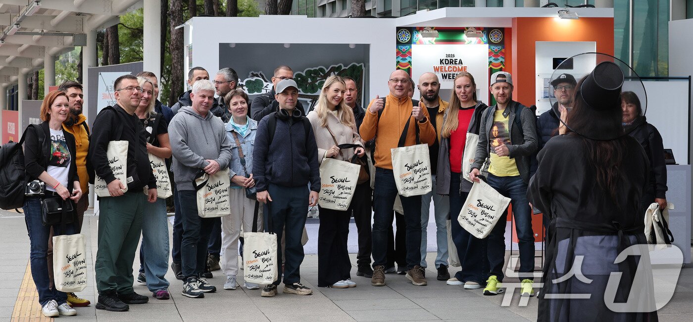 본문 이미지 - 2025 경주 아시아태평양경제협력체&#40;APEC&#41; 정상회의 주간 시작을 하루 앞둔 가운데 26일 경북 경주역에 도착한 러시아 경제인들이 웰컴 키트를 받은 뒤 기념 촬영을 하고 있다. 2025.10.26/뉴스1 ⓒ News1 박지혜 기자