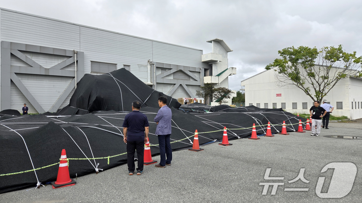 (무안=뉴스1) 이승현 기자 = 4일 전남 무안국제공항에서 12·29 제주항공 참사 유가족들이 격납고 인근에 보관 중인 사고 여객기 꼬리날개를 살피고 있다. (유가족협의회 제공. …