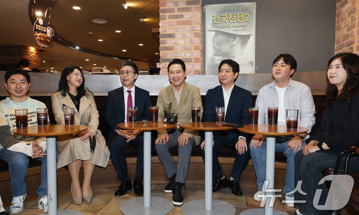 본문 이미지 - 장동혁 국민의힘 대표&#40;가운데&#41;가 7일 오후 서울 영등포구 롯데시네마 영등포점에서 영화 &#39;건국전쟁2&#39; 관람을 앞두고 김덕영 감독&#40;왼쪽 세번째&#41;과 대화를 나누고 있다. 2025.10.7/뉴스1 ⓒ News1 오대일 기자