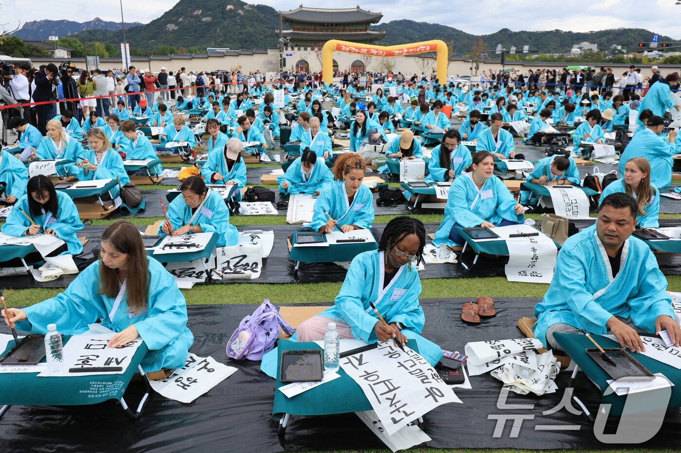본문 이미지 - 제579돌 한글날을 맞이한 9일 서울 종로구 광화문광장에서 열린 ‘2025 제 16회 광화문광장 휘호대회‘에 참가한 외국인들이 한글을 쓰고 있다. 2025.10.9/뉴스1 ⓒ News1 이호윤 기자
