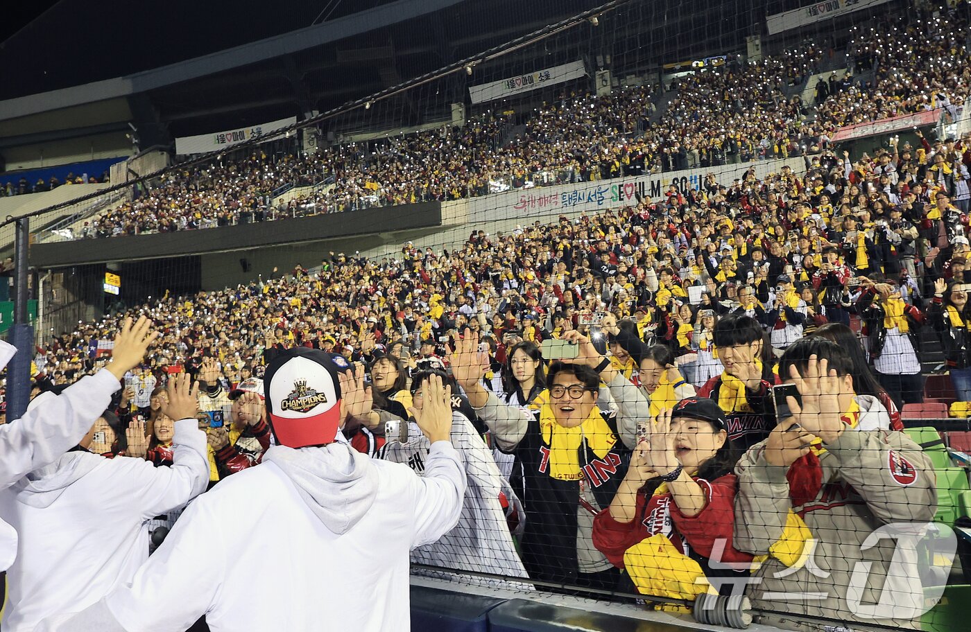 본문 이미지 - 1일 서울 송파구 잠실야구장에서 열린 프로야구 2025 한국시리즈 우승 세리머니 팬 감사 행사 &#39;더 리턴 오브 챔피언스&#39;&#40;The Return of Champions&#41;&#39;에서 LG트윈스 선수단이 그라운드 행진을 하며 팬들에게 손 맞춤을 하고 있다.2025.11.1/뉴스1 ⓒ News1 이호윤 기자