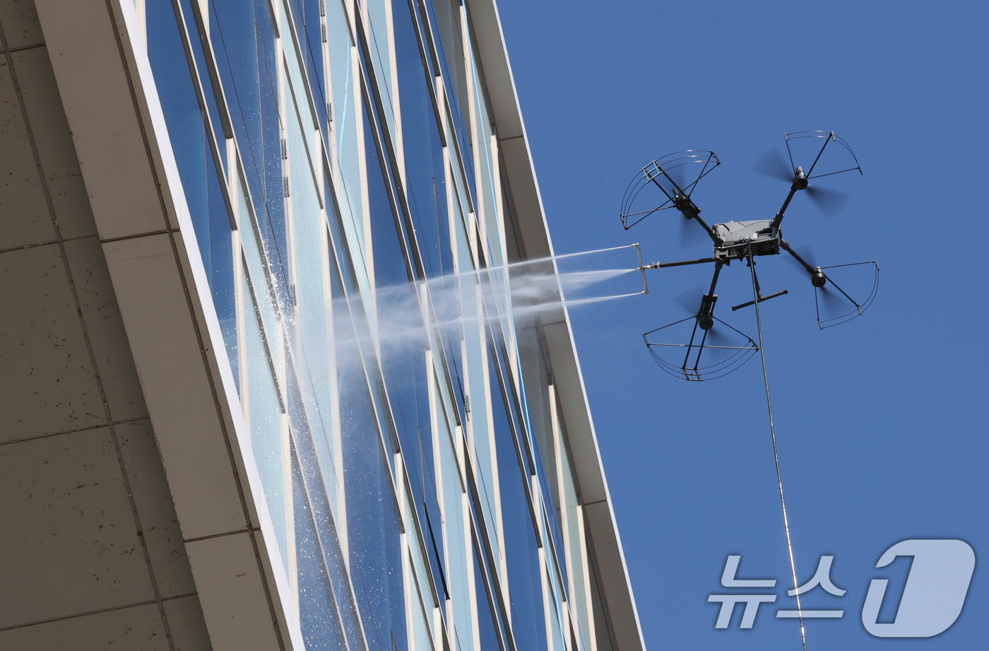 (대전=뉴스1) 김기태 기자 = 10일 오전 대전 동구청에서 업체 관계자가 드론을 활용해 강력한 청사 외벽을 청소하고 있다.동구는 고층부 작업의 특성상 추락 위험이 상존하고 작업자 …