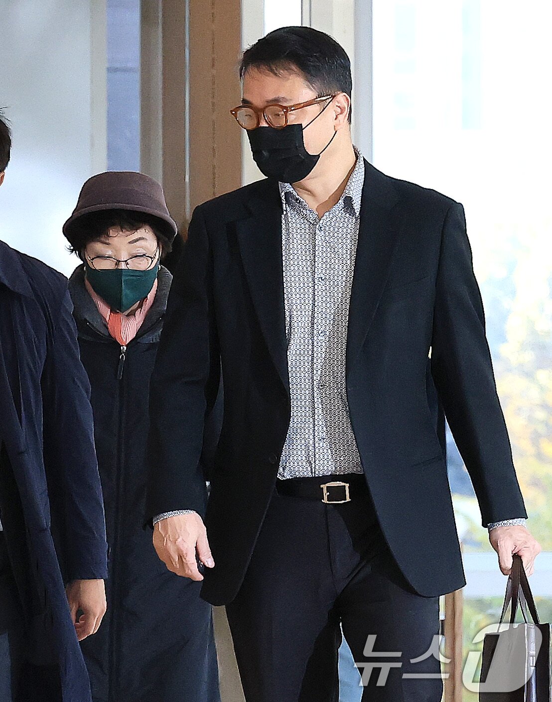 본문 이미지 - 윤석열 전 대통령의 부인 김건희 여사의 모친 최은순씨와 오빠 김진우씨가 11일 오전 서울 종로구 KT광화문빌딩 웨스트에 마련된 김건희특검 사무실에 피의자 신분으로 출석하고 있다. 2025.11.11/뉴스1 ⓒ News1 임세영 기자