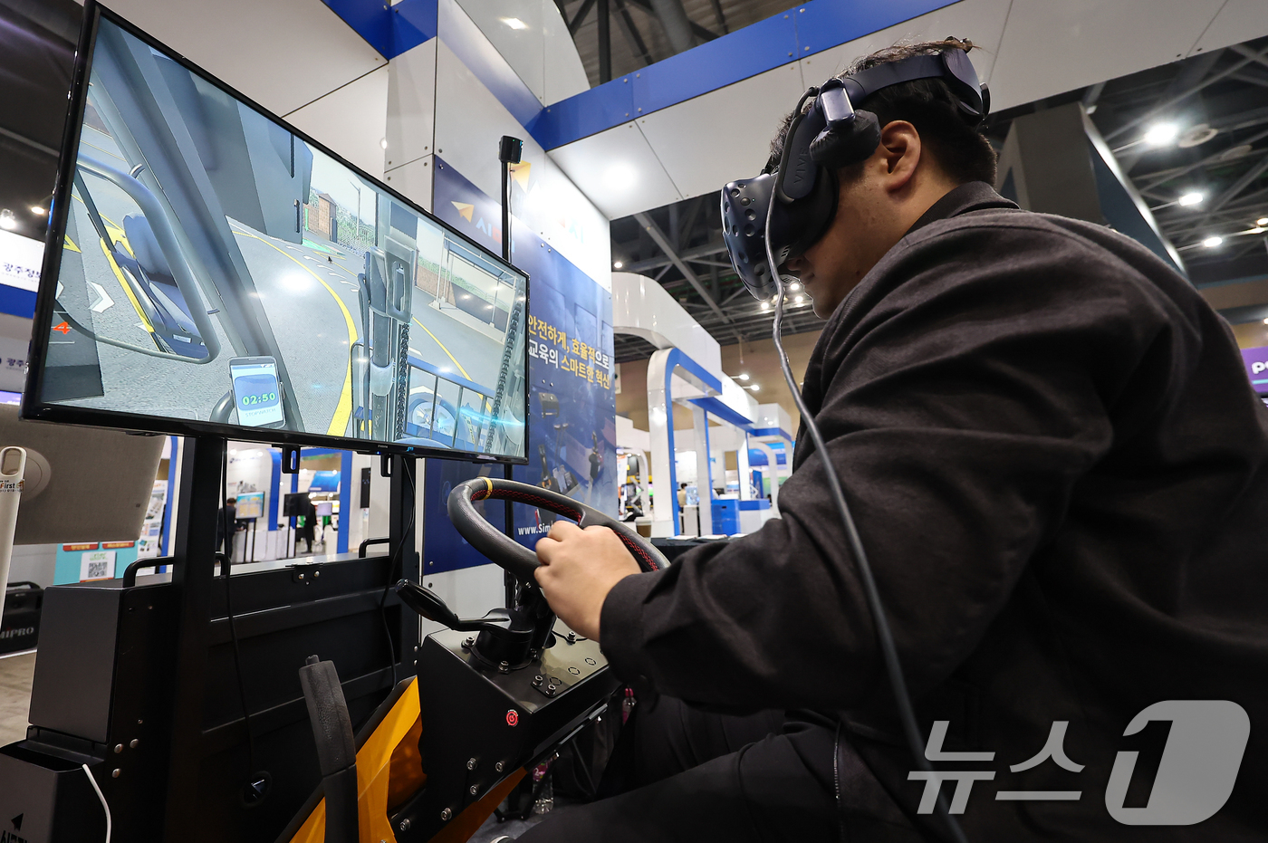 (고양=뉴스1) 김도우 기자 = 12일 경기 고양시 킨텍스에서 열린 2025 대한민국 가상융합산업대전에서 관람객이 VR(가상현실)을 활용한 중장비 교육을 체험하고 있다. 2025. …