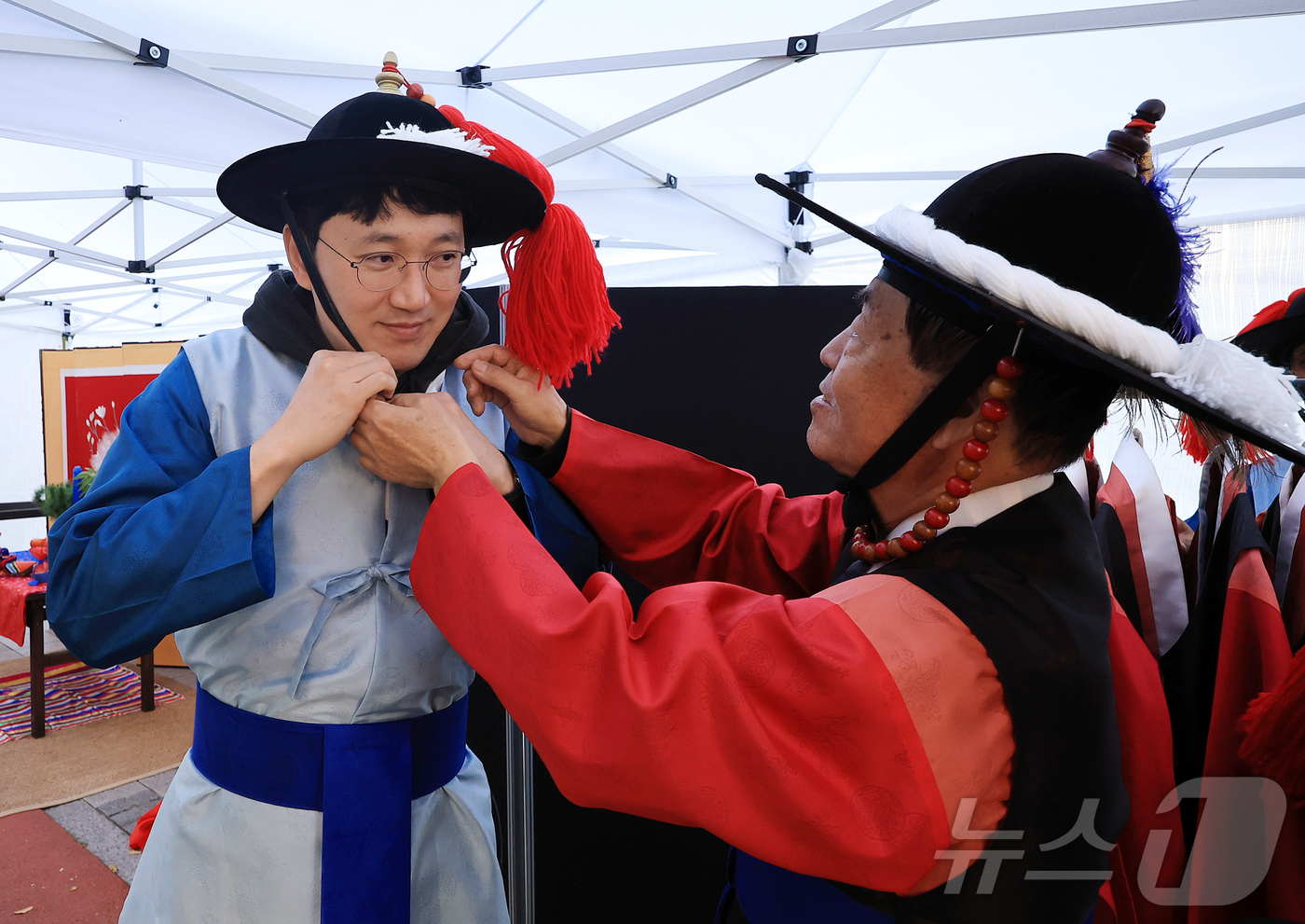 (서울=뉴스1) 김진환 기자 = 15일 오후 서울 종로구 청계천 장통교 일원에서 열린 '2025 육의전 축제'를 찾은 한 시민이 순라군 체험을 위해 전통 의상을 착용하고 있다. 2 …