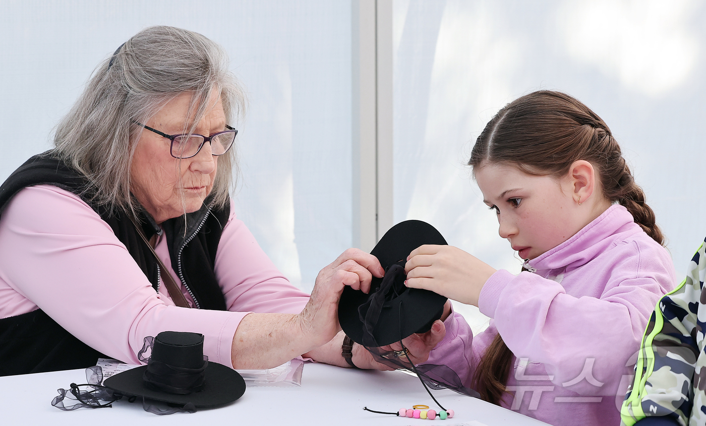 (서울=뉴스1) 김진환 기자 = 15일 오후 서울 종로구 청계천 장통교 일원에서 열린 '2025 육의전 축제'를 찾은 한 외국인 가족이 갓 만들기 체험을 하고 있다. 2025.11 …