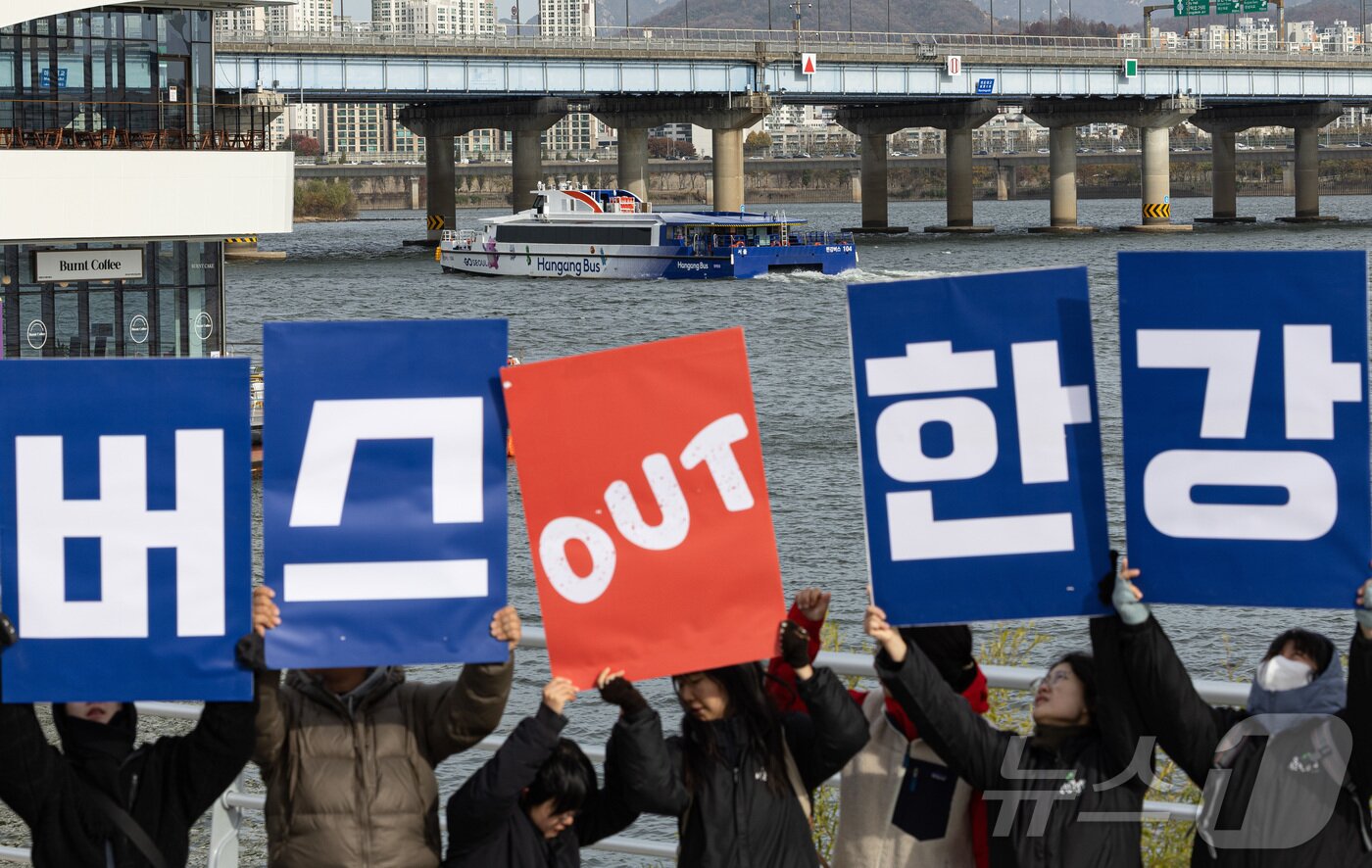 본문 이미지 - 서울환경연합 회원들이 17일 서울 여의도 한강버스 선착장 앞에서 열린 ‘강바닥 좌초 사고에도 운항을 강행하는 서울시 규탄 및 한강버스 사업 전면 재검토 촉구’ 기자회견에서 구호를 외치고 있다.  2025.11.17/뉴스1 ⓒ News1 이재명 기자