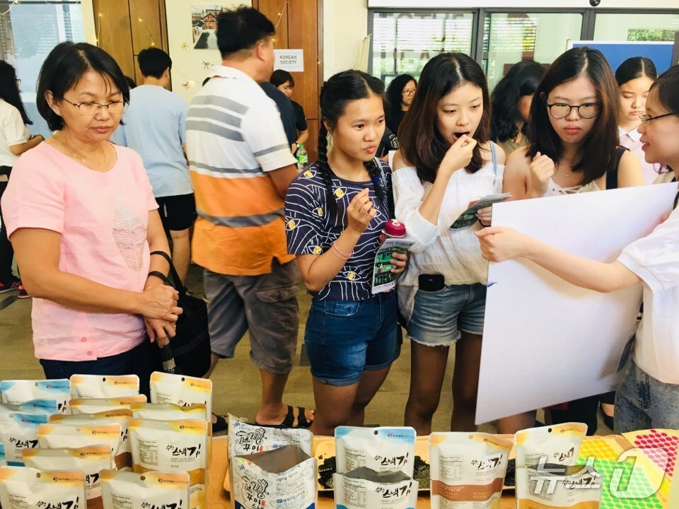 본문 이미지 - &#39;김스낵&#39;을 맛보고 있는 말레이시아인들&#40;쿠알라룸푸르 수산물 수출지원센터 제공&#41;