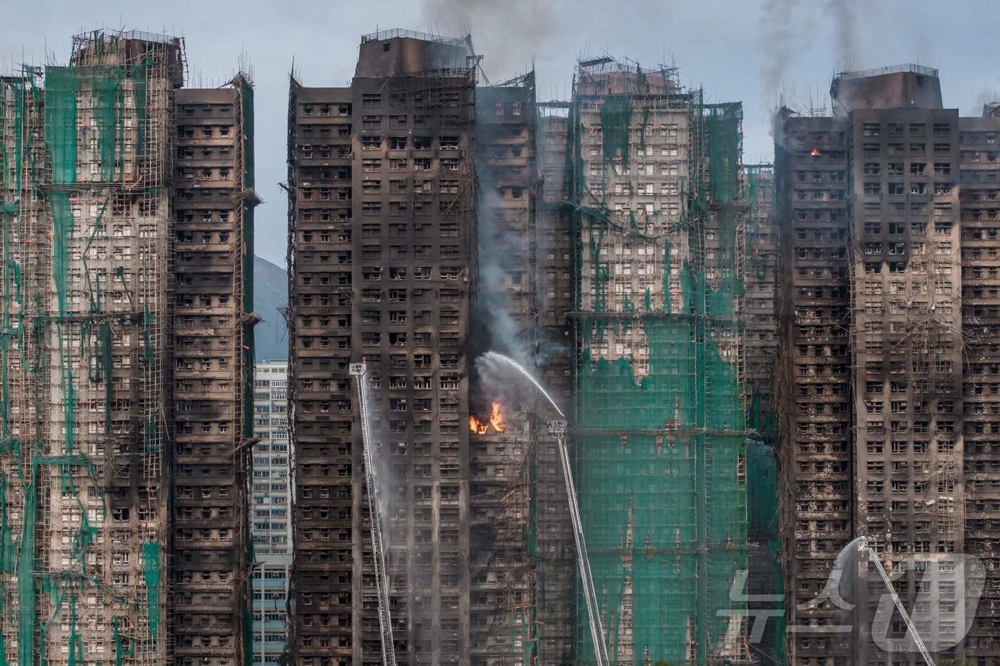 본문 이미지 - 27일 홍콩 타이포 지역 왕 푹 콕 아파트 단지 화재 현장. 주불은 진압됐지만, 아직 잔불이 남아 있어 소방 작업이 지금도 진행 중이다. ⓒ AFP=뉴스1 ⓒ News1 임세영 기자