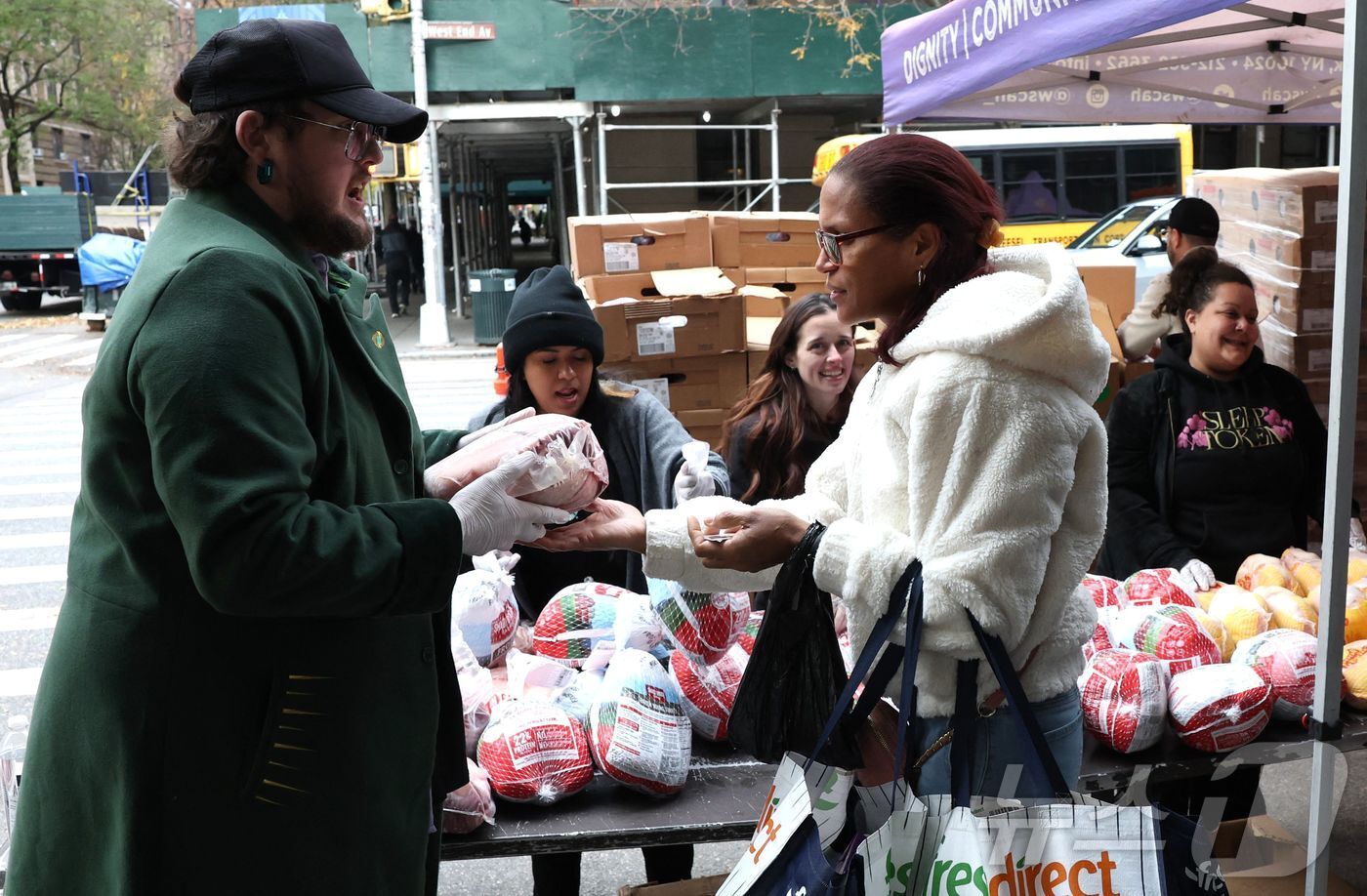 본문 이미지 - 지난 25일&#40;현지시간&#41; 미국 뉴욕 웨스트사이드 기아퇴치캠페인&#40;WSCAH&#41;에서 한 여성이 추수감사절 음식을 받고 있다. WSCAH는 뉴욕시에서 가장 크고 성공적인 푸드 뱅크 중 하나다. 2025.11.25. ⓒ AFP=뉴스1 ⓒ News1 이정환 기자
