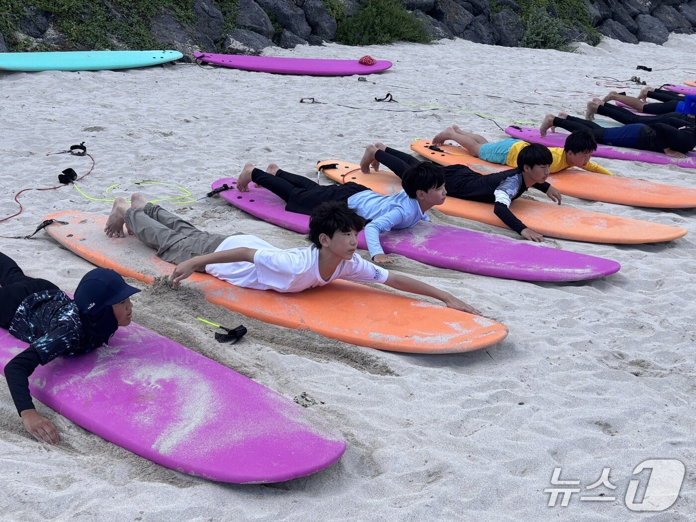 본문 이미지 - 제주 평대초 아이들이 교과과정 중 서핑을 배우고 있는 모습.&#40;평대초 제공&#41;