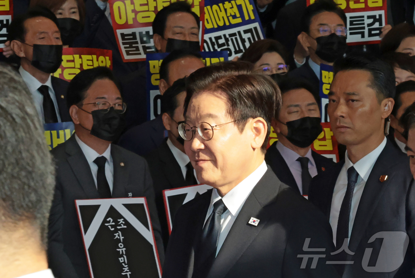 (서울=뉴스1) 국회사진기자단 = 이재명 대통령이 4일 오전 서울 여의도 국회에서 시정연설을 위해 이동하는 가운데 국민의힘 의원들이 검은 양복과 넥타이를 메고 마스크를 착용한 채 …