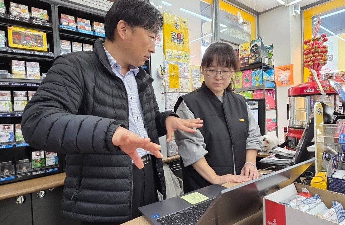 본문 이미지 - 경기도 화성시에서 이마트24를 운영 중인 이미연 경영주가 영업팀장으로부터 설명을 듣고 있다. (이마트24 제공). 