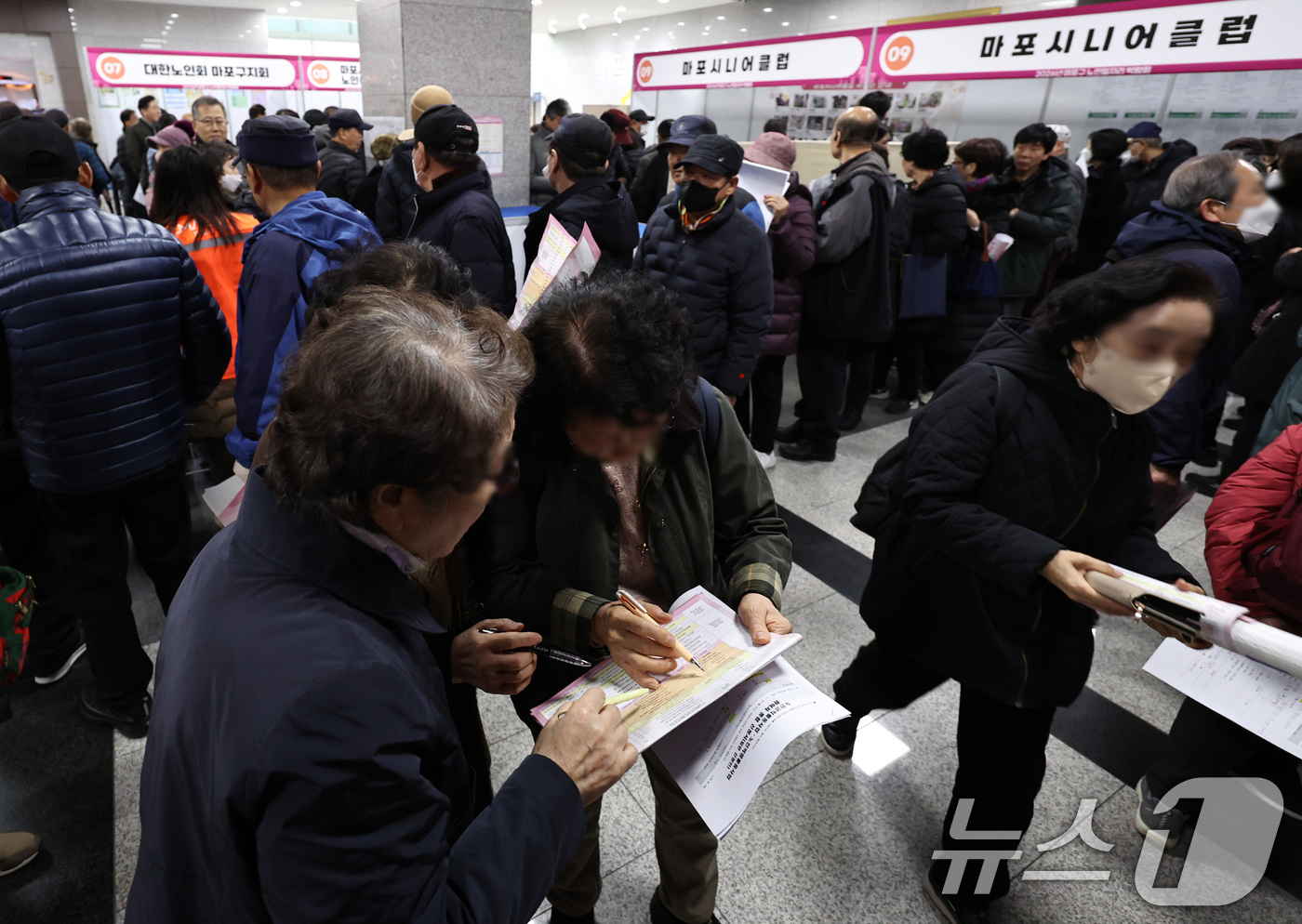 (서울=뉴스1) 구윤성 기자 = 10일 오후 서울 마포구청에서 열린 노인일자리 박람회에서 어르신들이 참가업체 모집요강을 살펴보고 있다. 2025.12.10/뉴스1