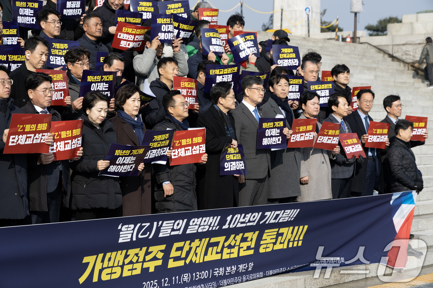 (서울=뉴스1) 이승배 기자 = 11일 서울 여의도 국회 본청 계단에서 열린 가맹점주 단체교섭권 통과 촉구 기자회견에서 참가자들이 법안 통과를 촉구하고 있다. 2025.12.11/ …