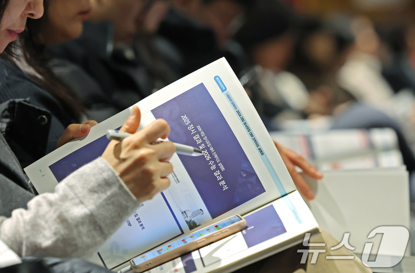(서울=뉴스1) 장수영 기자 = 13일 오전 서울 성북구 고려대 인촌기념관에서 열린 서울시교육청 2026 대입 정시모집 대비 진학설명회를 찾은 수험생 학부모가 입시 설명 자료를 살 …
