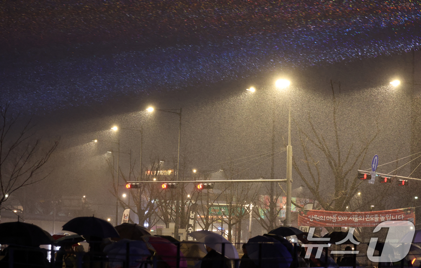 (서울=뉴스1) 김명섭 기자 = 13일 오후 서울 광화문광장에서 시민들이 눈을 맞으며 윈터페스타를 즐기고 있다.윈터페스타는 2026년 1월 4일까지 광화문·청계천·DDP·서울광장· …