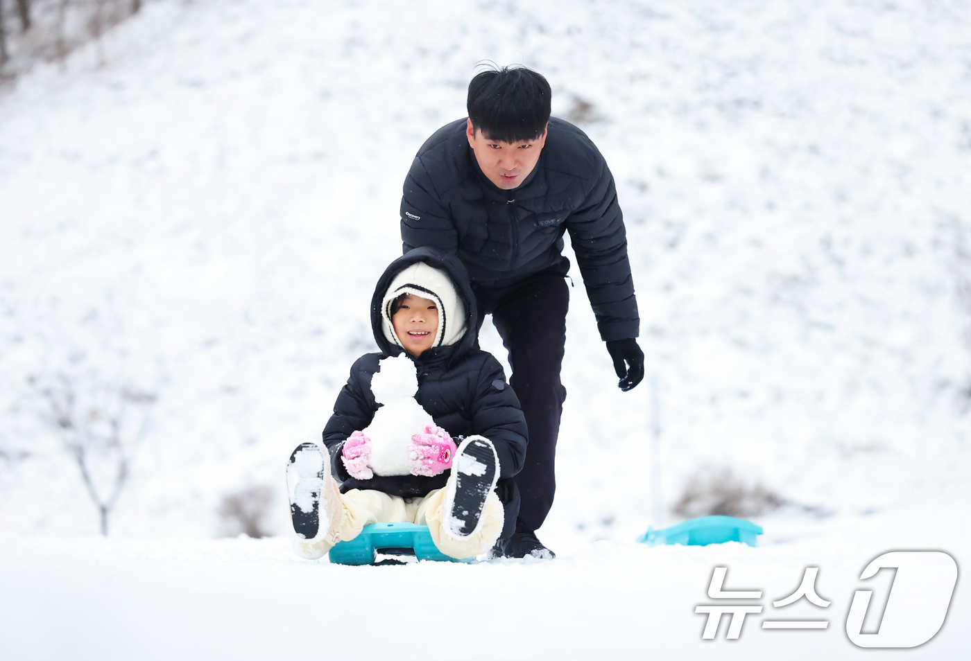 (서울=뉴스1) = 밤새 눈이 내린 14일 경남 함양군 휴천면 ‘지리산 풍경길’ 대한민국 관광도로 1호 선정된 지리산 제1문 오도재에서  한 가족이 눈썰매 타며 즐기운 시간을 보내 …