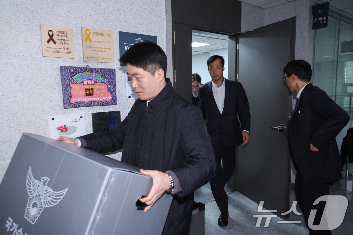 (서울=뉴스1) 신웅수 기자 = 15일 서울 여의도 국회 의원회관에 마련된 전재수 더불어민주당 의원실에서 경찰 수사관들이 압수수색을 마친 후 의원실을 나서고 있다. 2025.12. …