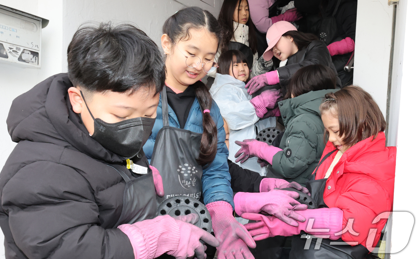 (대전=뉴스1) 김기태 기자 = 17일 대전 동구 신흥동 일원에서 대전국제학교 학생들이 연탄 나눔 봉사를 하고 있다. 2025.12.17/뉴스1