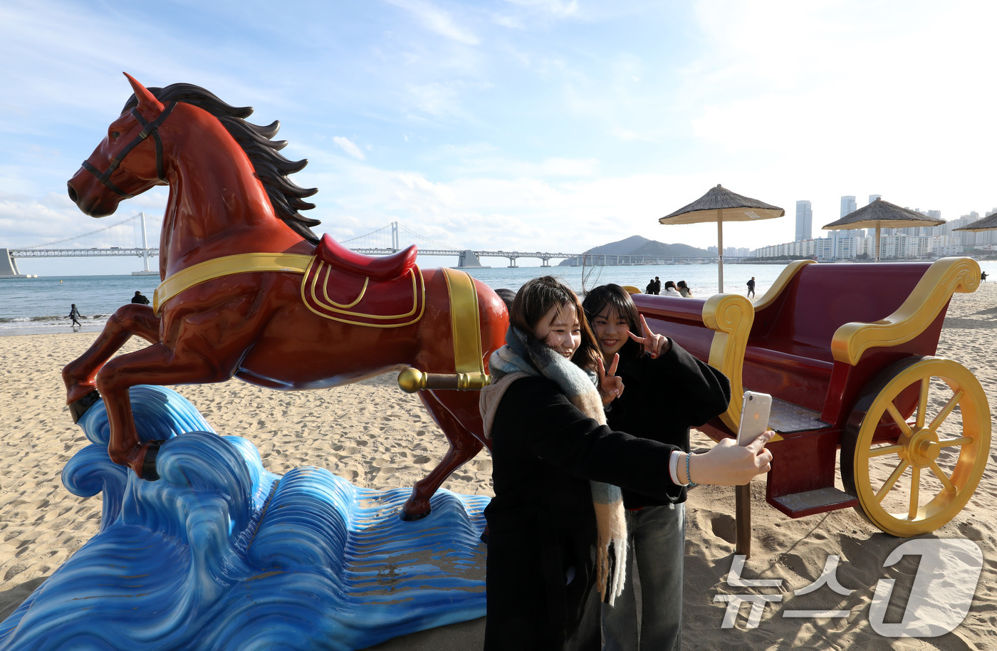 (부산=뉴스1) 윤일지 기자 = 22일 오후 부산 수영구 광안리해수욕장을 찾은 관광객들이 2026년 병오년(丙午年) 붉은 말의 해를 맞아 설치된 새해 말 조형물에서 기념사진을 찍고 …