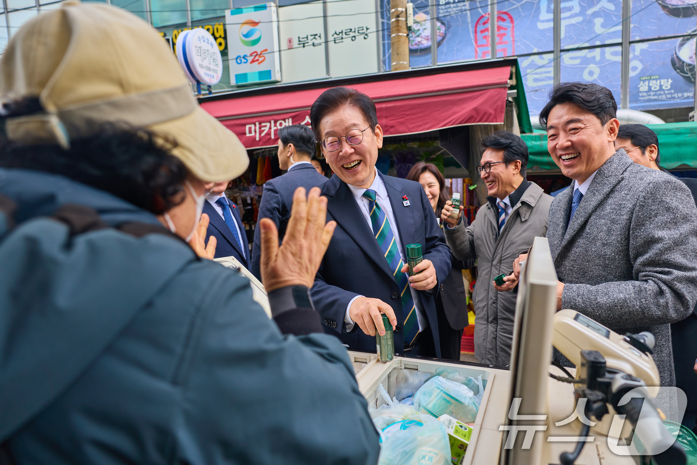 (서울=뉴스1) 이재명 기자 = 이재명 대통령이 23일 부산 진구 부전시장을 찾아 상인들과 대화하고 있다. (대통령실 제공. 재판매 및 DB 금지) 2025.12.23/뉴스1